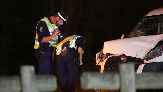 Officers inspect the front end of the vehicle. Picture: Tim Pascoe