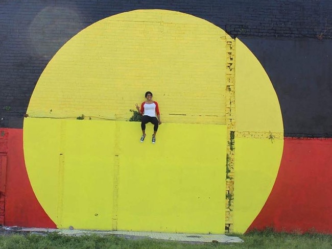 Roosters star Taleena Simon at the Aboriginal flag mural in Redfern.