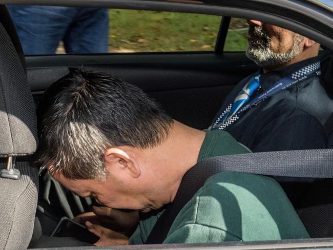 Zhen Jie Zhang is taken away by Queensland police after he was extradited to Queensland in connection an alleged kidnapped of 12 year old boy on the Gold Coast on Friday.