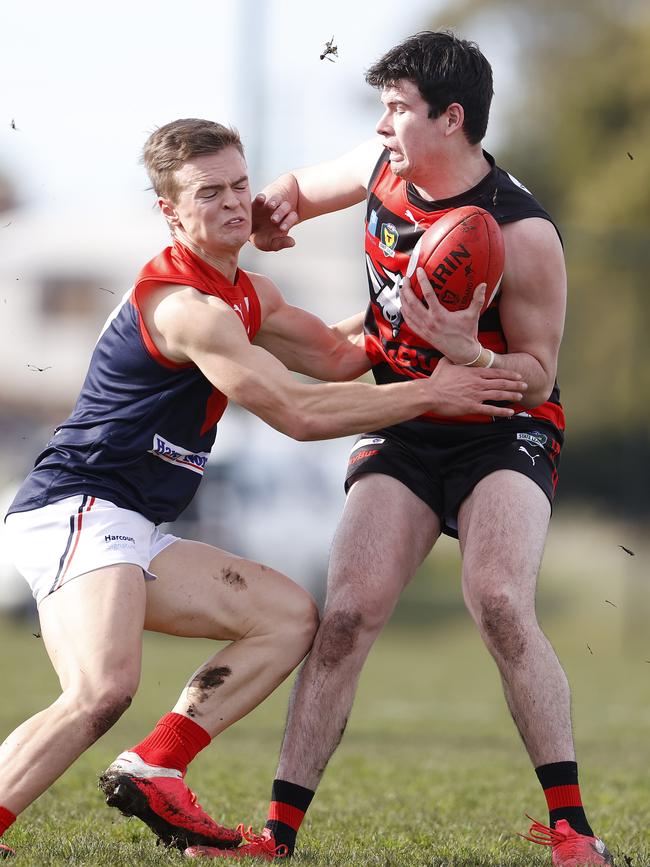 Lauderdale's William Frances attempts to fend off North Hobart's Thomas Reeves. Picture: ZAK SIMMONDS