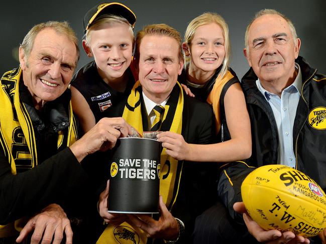 Glenelg Football Club legend Graham Cornes, fan Joe Chigwidden (11), club president Nick Chigwidden, fan Summer Ryan (12), & Club legend Peter Carey at the launch of the club's 'Save the Tigers' fund. Pictured at Phil Hoffman travel, Glenelg. picture: Bianca De Marchi