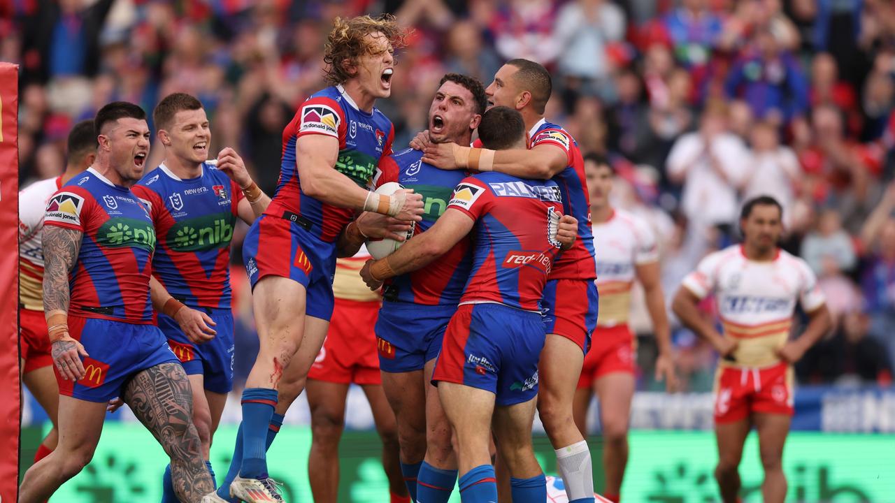 Adam Elliott and the Knights celebrate the opening try against the Dolphins. (Photo by Scott Gardiner/Getty Images)