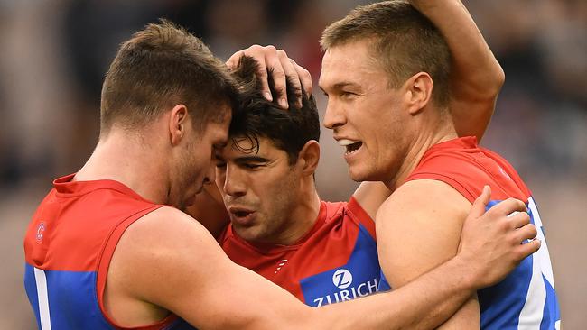 Jesse Hogan, Christian Petracca and Tom McDonald celebrate a goal on Sunday. Picture: AAP Images