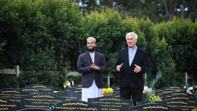 Burying the story: Father Joseph Kolodziej from All Hallows Catholic Church at Five Dock and Mohammad Abu Hurayra Imam, Masjid St Marys Mosque in the Muslim section of Rookwood Cemetery at Lidcombe in Sydney's west. Picture: John Feder