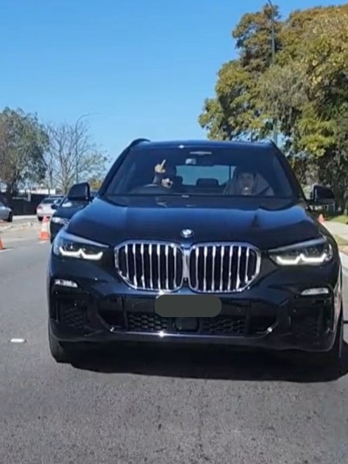 The driver of the vehicle flashes a middle finger at the car ahead of them. Picture: TikTok