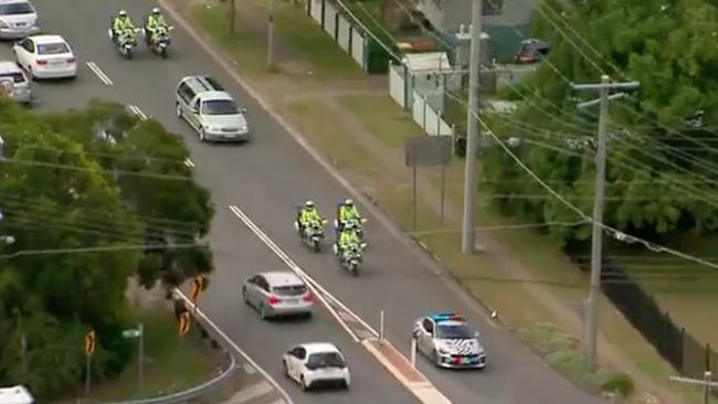 A police escort for the hearse carrying Alan Dare’s coffin. Picture: 7 NEWS