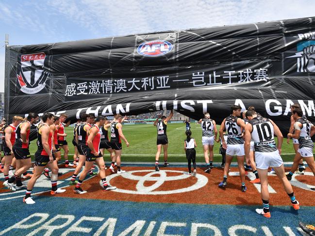 Players run through the banner during the Round 11 AFL match between the St Kilda Saints and Port Adelaide Power at Jiangwan Stadium, Shanghai, China, Sunday, June 2, 2019. (AAP Image/David Mariuz) NO ARCHIVING, EDITORIAL USE ONLY