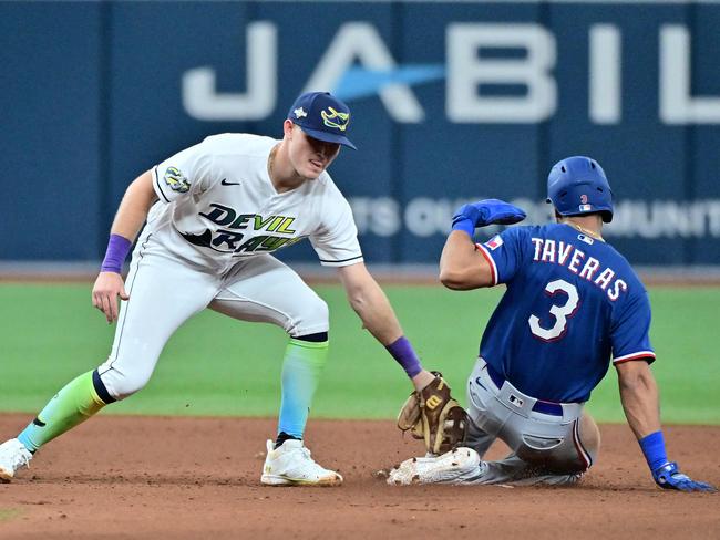 ST PETERSBURG, FLORIDA - OCTOBER 03: Curtis Mead #25 of the Tampa Bay Rays tags Leody Taveras #3 of the Texas Rangers out on an attempted steal in the ninth inning during Game One of the Wild Card Series at Tropicana Field on October 03, 2023 in St Petersburg, Florida.   Julio Aguilar/Getty Images/AFP (Photo by Julio Aguilar / GETTY IMAGES NORTH AMERICA / Getty Images via AFP)