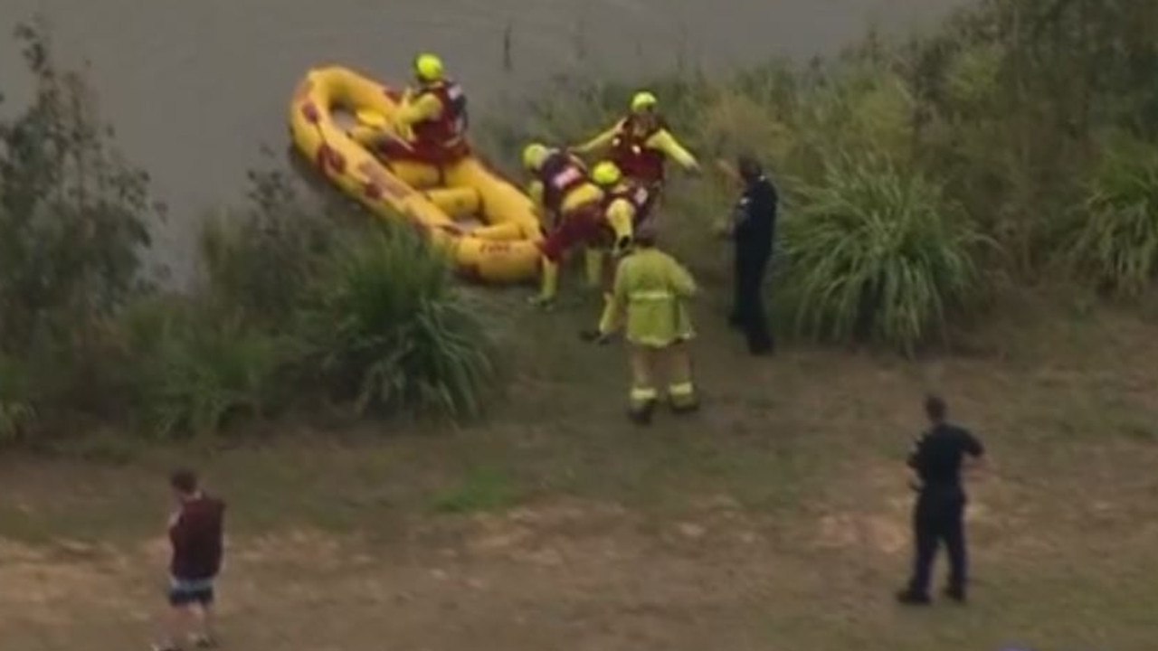 QFES teams are performing a swift water rescue at a dam in Jimboomba. Credit: 7News