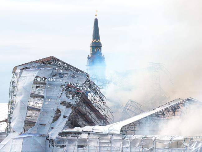 Smoke billows from Copenhagen’s historic Boersen stock exchange, which was built in the 1620s by King Christian IV. The building, which was undergoing renovations, caught fire for reasons yet to be investigated. Picture: Emil Helms/Ritzau Scanpix/AFP