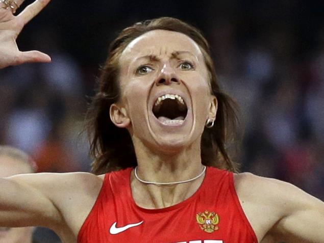 FILE - In this Aug. 11, 2012 file photo Russia's Mariya Savinova celebrates as she crosses the finish line ahead of South Africa's Caster Semenya during the athletics in the Olympic Stadium at the 2012 Summer Olympics, London. (AP Photo/Anja Niedringhaus, file)