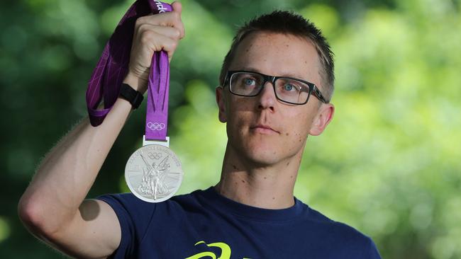 Olympian Jared Tallent with his silver medal which has now been replaced by gold.