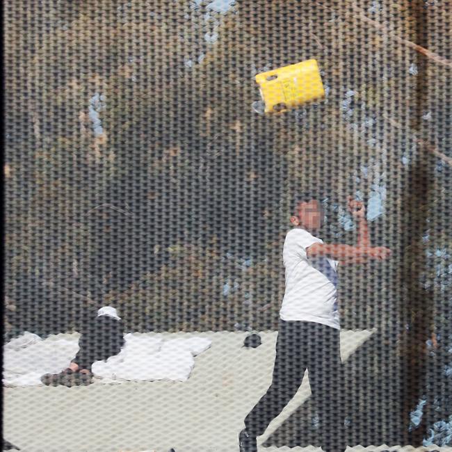 Inmates from the Frank Baxter Juvenile corrections centre Kariong taunt police from the roofs of various buildings. Some are armed with poles tennis rackets ect .picture John Grainger