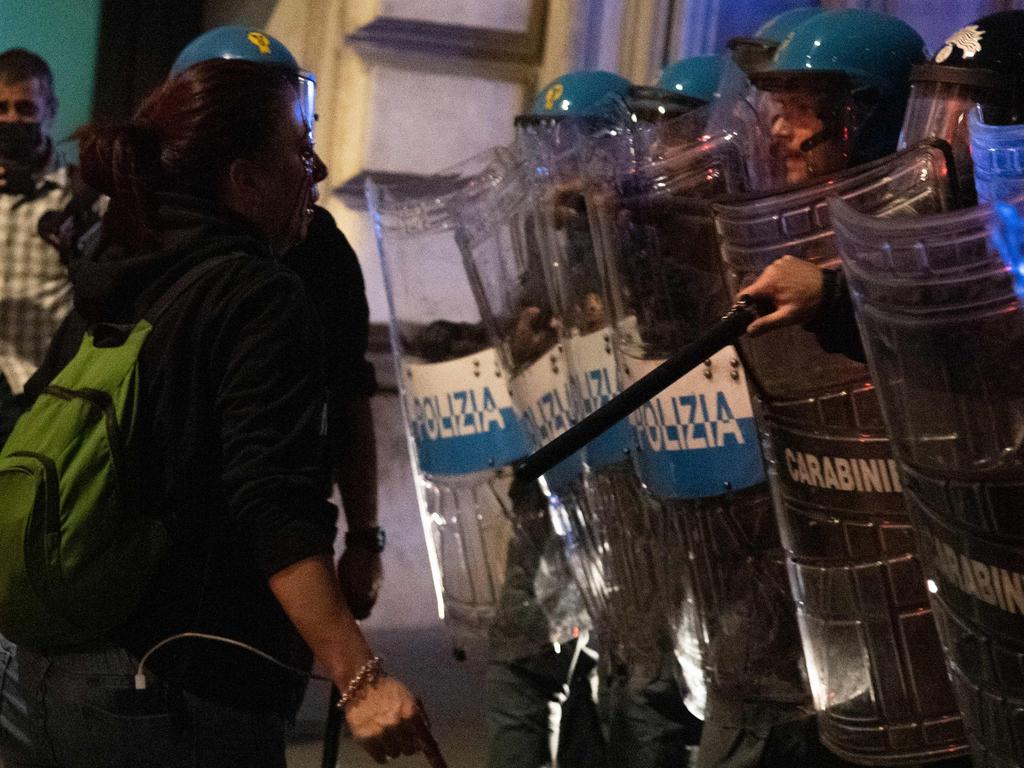 Protester Pamela Testa faces a cordon of Polizia and Carabinieri police officers during clashes following a protest against the mandatory sanitary pass. Picture: AFP