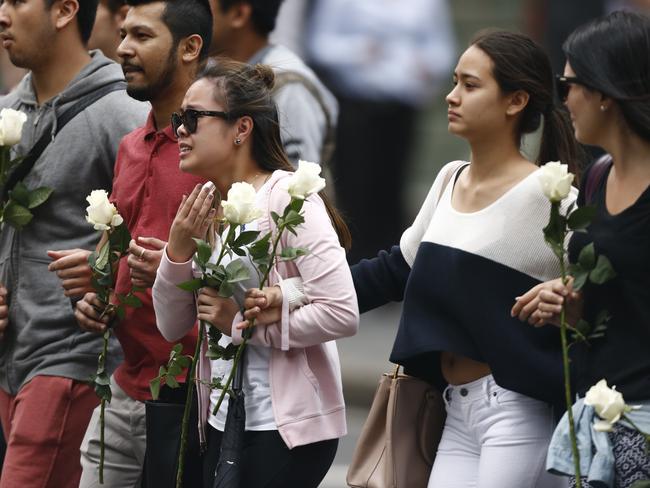 A woman believed to be a distraught Elly Chen and her grieving Lindt Cafe workmates. Picture: Tim Hunter.