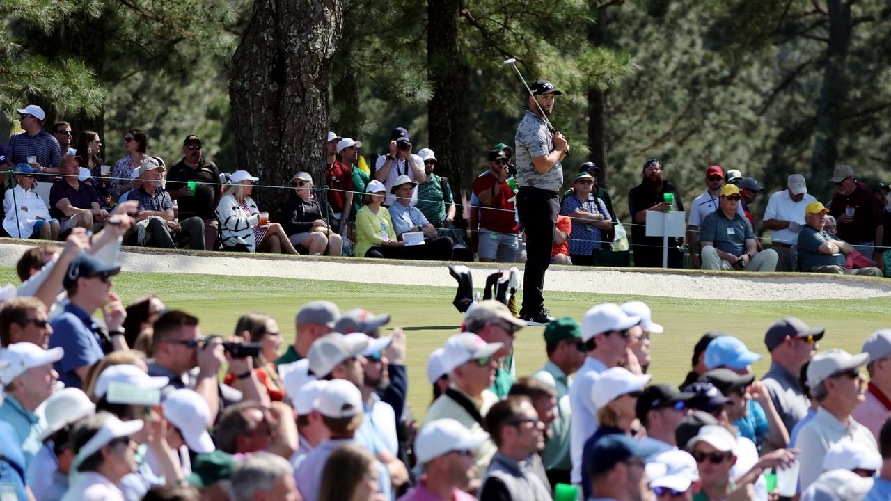 Jon Rahm of Spain watches the crowd following Tiger Woods