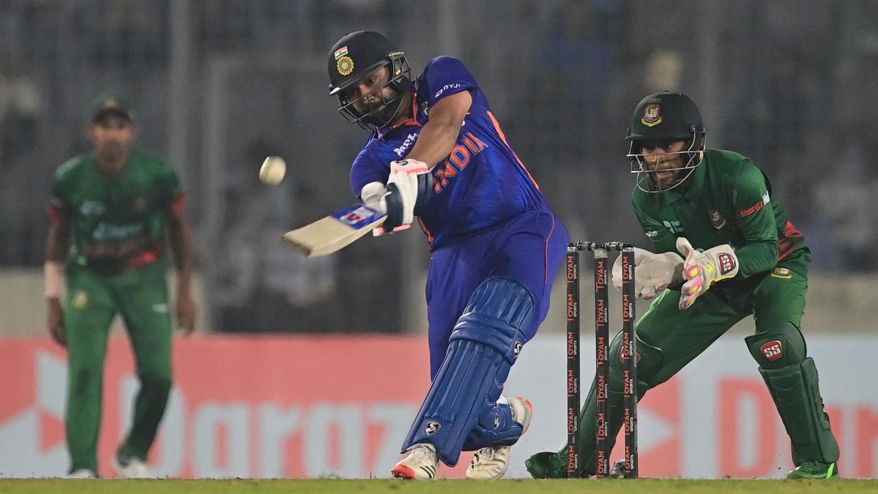 India's captain Rohit Sharma (C) plays a shot during the second one-day international (ODI) cricket match between Bangladesh and India at the Sher-e-Bangla National Cricket Stadium in Dhaka on December 7, 2022. (Photo by Munir uz ZAMAN / AFP)