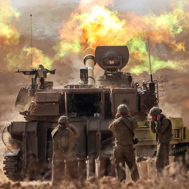 An Israeli army self-propelled howitzer fires rounds near the border with Gaza in southern Israel on October 11, 2023.