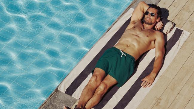 Model turned entrepreneur David Gandy relaxes in his David Gandy Wellwear swim shorts.