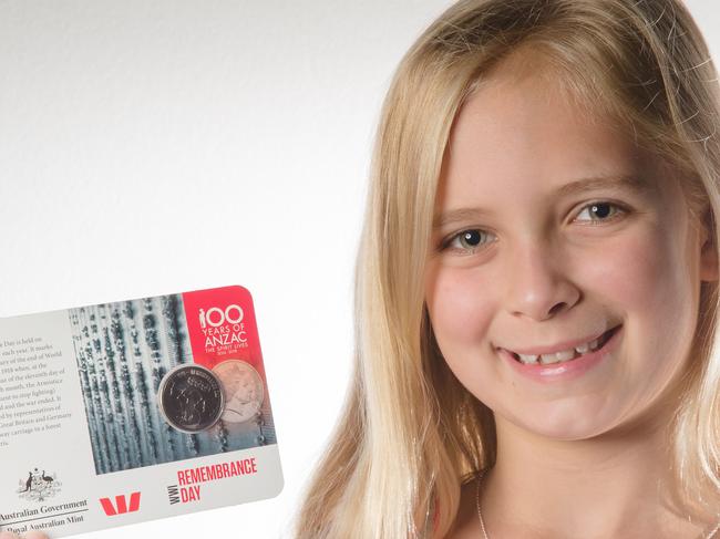 Eden Laura Powell, 9 from Perth WA with the Rememberance Day coin for the Anzac Coins promotion, this will be shared across the group. Each of them has a connection with a Digger family. Picture: Jonathan Ng