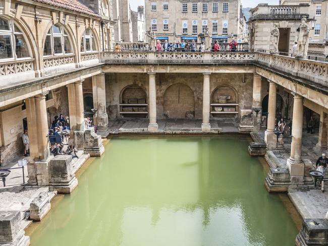 Bath, United Kingdom. A view of tourists walking around the main pool at the Roman Baths in Bath, England.Escape 27 August 2023Destinations - Solsbury Hill/BathPhoto - iStock