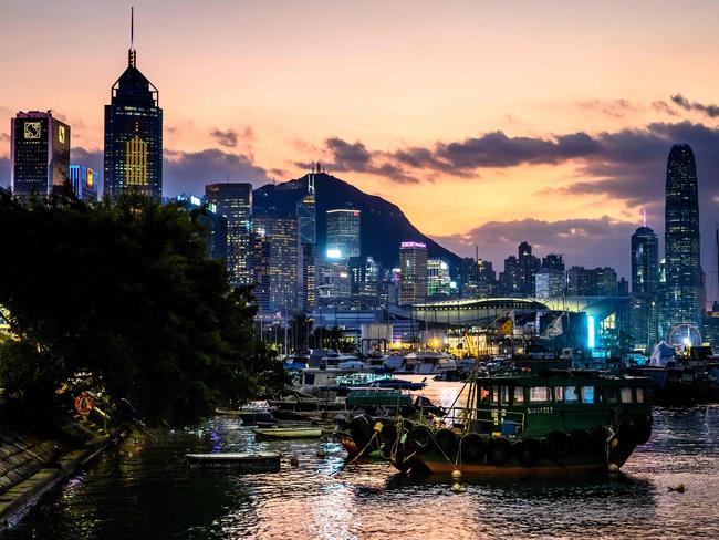 The sun sets behind Hong Kong's skyline on November 1, 2024. (Photo by Mladen ANTONOV / AFP)