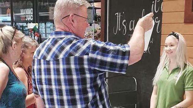 The 24-year-old can be seen smiling as she helps customers at the Barr St Markets on Saturday. PICTURE: SUPPLIED