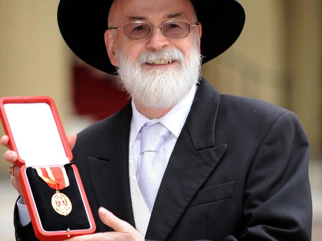 Honoured ... British author Sir Terry Pratchett posing for pictures with his knighthood award outside Buckingham Palace in London in 2009. Picture: AFP