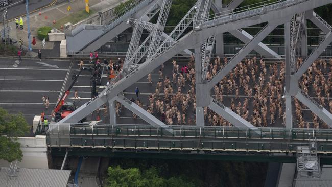 Thousands of people are pictured as they take part in Rising Tide - a monumental installation of volunteer nude models created by New York artist Spencer Tunick for Melt Festival 2024 on Brisbane's Story Bridge. Picture: NewsWire/ David Kapernick