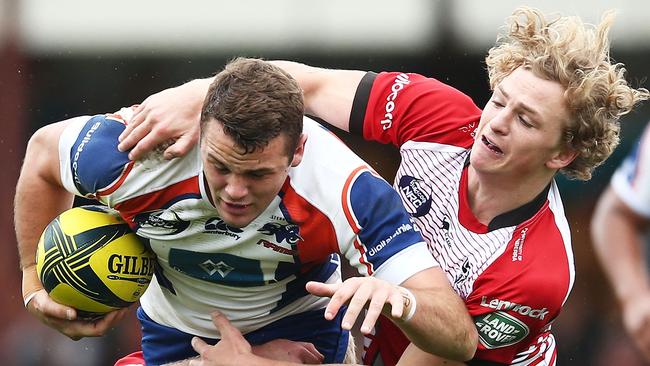 Paul Asquith of the Rams is tackled at Viking Park.