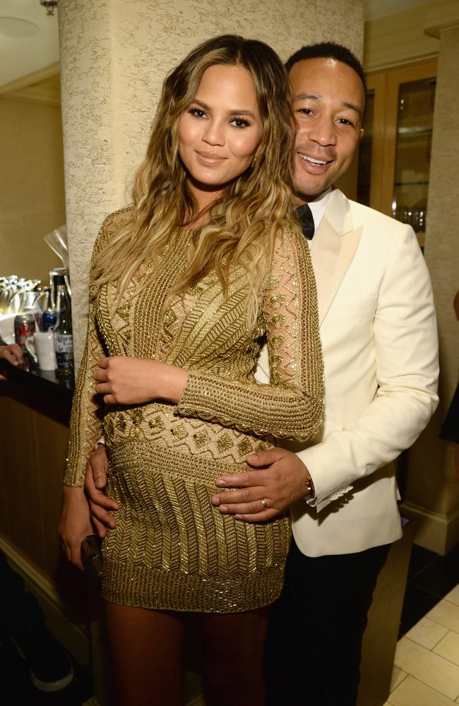 LAS VEGAS, NV - DECEMBER 02: Model Chrissy Teigen and recording artist John Legend pose backstage during 