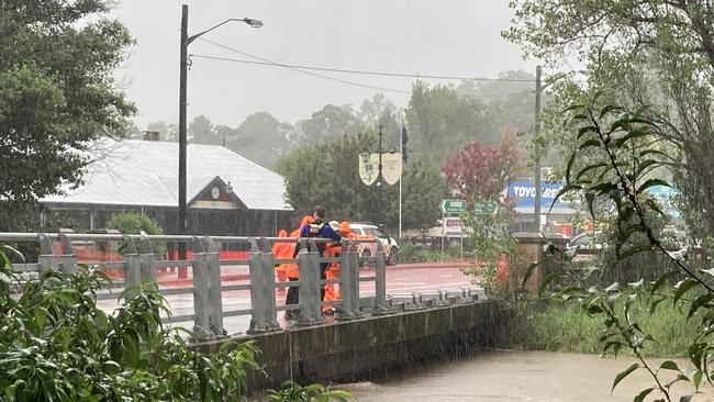 On Wednesday, local SES units worked to flatten the sides of the Picton bridge to allow the water to flow over the bridge without flooding the main street. Picture: Adelaide Lang