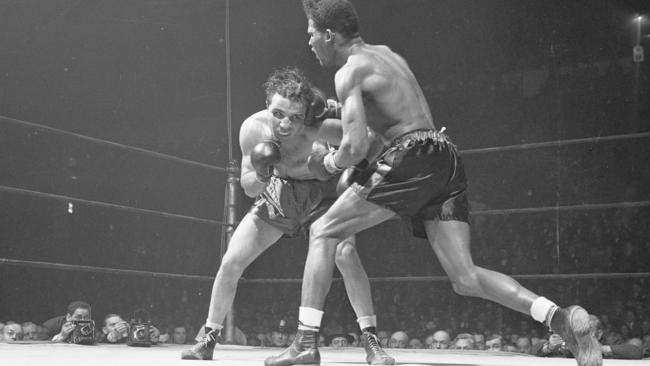 FILE - In this Feb. 23, 1945, file photo, Jake LaMotta, left, of the Bronx borough of New York, and Ray Robinson of the Harlem section of New York, fight at Madison Square Garden in New York. Robinson won the fight on a decision. LaMotta fought Sugar Ray Robinson six times, handing Robinson his first defeat. LaMotta, whose life was depicted in the film â€œRaging Bull,â€ died Tuesday, Sept. 19, 2017, at a Miami-area hospital from complications of pneumonia. He was 95. (AP Photo/Matty Zimmerman, File)