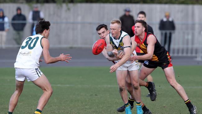 Tate Porter shoots out a handball. Picture: Alan Barber