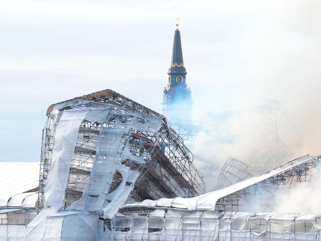 Plumes of smoke billow from the historic Borsen stock exchange building which is on fire in central Copenhagen, Denmark. Picture: AFP