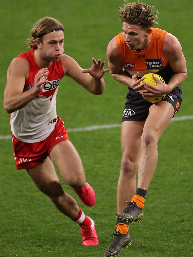 Lachie Whitfield marks against James Rowbottom. Picture: Paul Kane/Getty