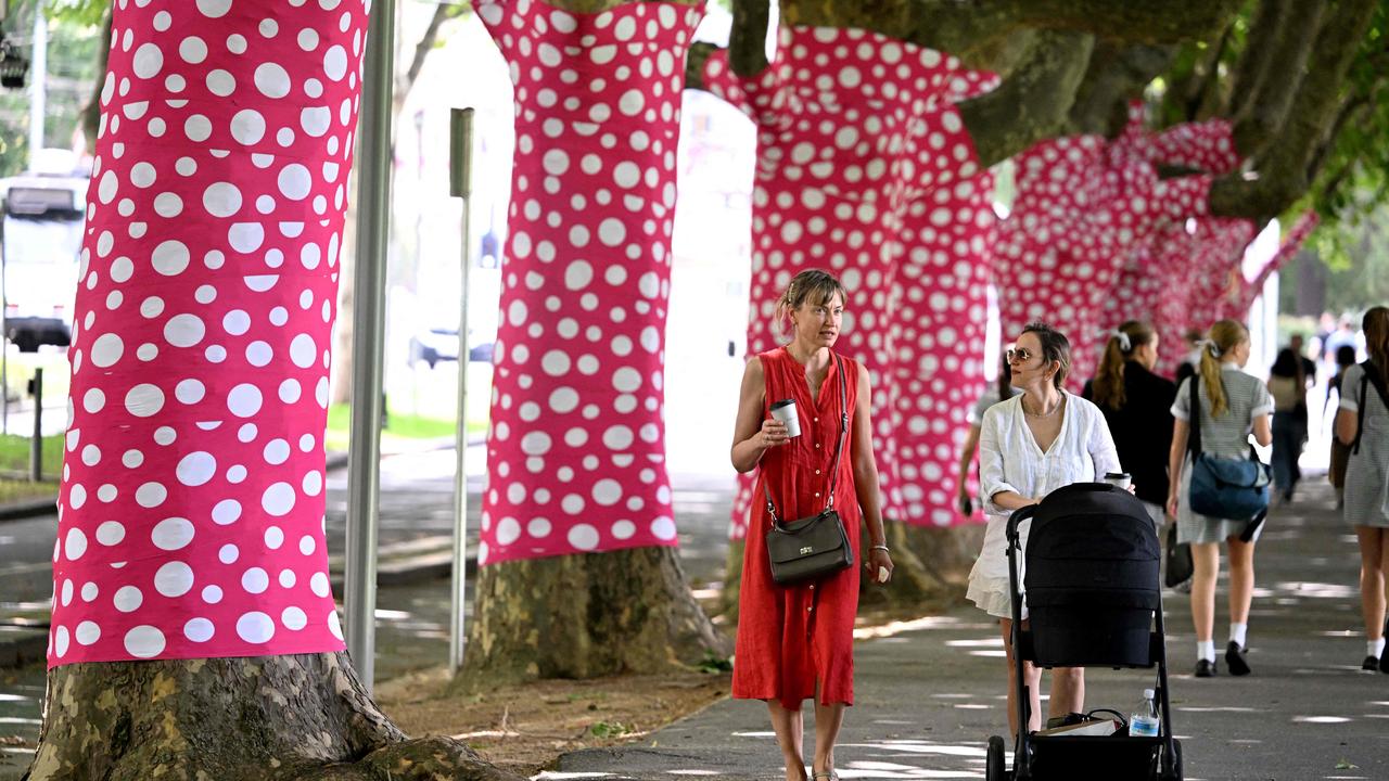 Sixty plane trees have been wrapped in a pink-and-white polka-dot design developed especially for Melbourne by Japanese contemporary artist Yayoi Kusama and titled Ascension of Polka Dots on the Trees. Picture: William West / AFP