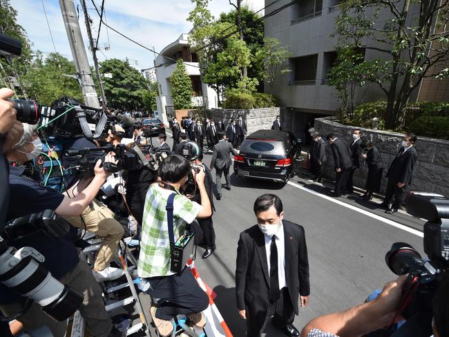 A hearse transporting the body of Mr Abe arrives at his residence in Tokyo on Saturday. Picture: AFP