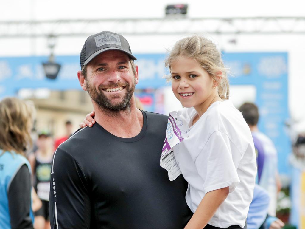 Layla Crilley, 7, with Dad Nick from the Gold Coast at the finish of the Two Kilometre Junior Dash. Picture: Tim Marsden.