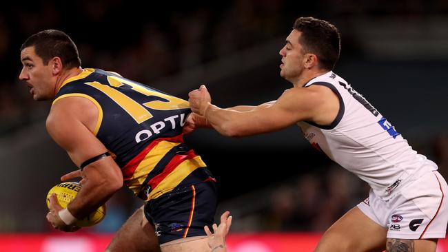 Crows Taylor Walker is tackled by GWS Giants Tim Taranto. Picture: James Elsby/Getty