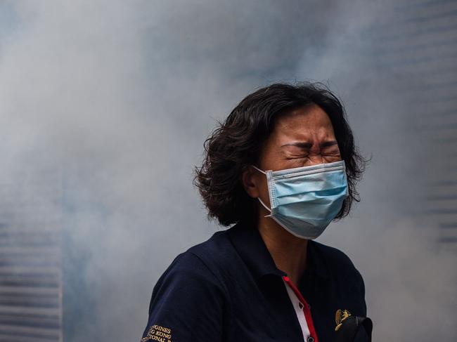 A woman reacts after riot police fired tear gas to disperse protesters taking part in a pro-democracy rally against a proposed new security law in Hong Kong. Picture: AFP