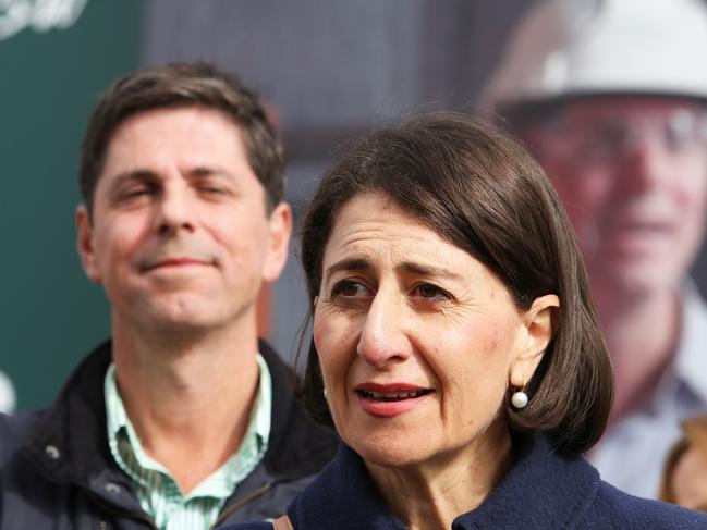 NEWCASTLE, AUSTRALIA - NewsWire Photos - May 22, 2021. Nationals candidate Dave Layzell votes in the Upper Hunter by-election at Muswellbrook Sports Centre with the support of Premier Gladys Berejiklian and Deputy John Barilaro.  Picture: NCA NewsWire / Peter Lorimer.