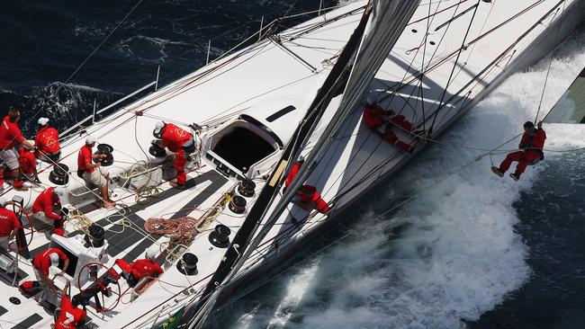 Sven Runow flies high to secures the spinnaker aboard Wild Oats XI in the 2008 race. Pic: Brett Costello.