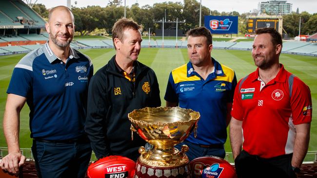 South Adelaide's Jarrad Wright, Glenelg's Mark Stone, Eagles’ Jade Sheedy and North Adelaide's Jacob Surjan with the premiership cup at Adelaide Oval. Picture Matt Turner