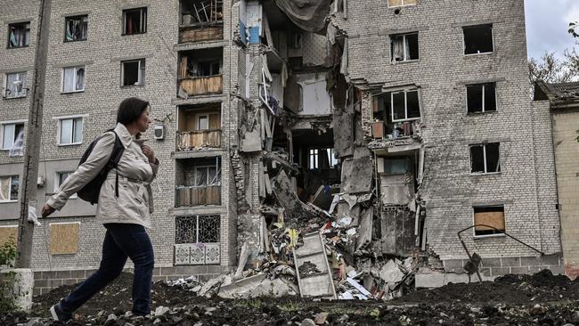 A woman walks by a destroyed apartment building in Bakhmut in the eastern Ukranian region of Donbass, amid Russian invasion of Ukraine. Picture: AFP.