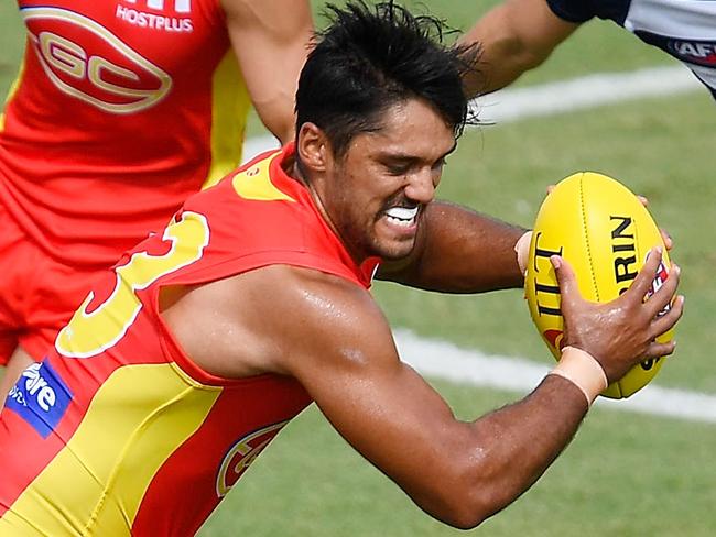 TOWNSVILLE, AUSTRALIA - MARCH 04:  Aaron Hall of the Suns is tackled by Jamaine Jones of the Cats during the AFL JLT Community Series match between the Geelong Cats and the Gold Coast Suns at  Riverway Stadium on March 4, 2018 in Townsville, Australia.  (Photo by Ian Hitchcock/Getty Images)