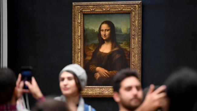 Visitors take pictures in front of Mona Lisa at the Louvre Museum in Paris. Picture: Eric Fedferberg / AFP