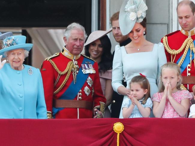 TOPSHOT - Members of the Royal Family (L-R) Vice Admiral Timothy Laurence, Britain's Princess Anne, Princess Royal, Britain's Princess Beatrice of York, Britain's Prince Andrew, Duke of York, Britain's Camilla, Duchess of Cornwall, Britain's Queen Elizabeth II, Britain's Prince Charles, Prince of Wales, Britain's Meghan, Duchess of Sussex, Britain's Prince Harry, Duke of Sussex, Britain's Catherine, Duchess of Cambridge (with Princess Charlotte and Prince George) and Britain's Prince William, Duke of Cambridge, stand on the balcony of Buckingham Palace to watch a fly-past of aircraft by the Royal Air Force, in London on June 9, 2018.   The ceremony of Trooping the Colour is believed to have first been performed during the reign of King Charles II. In 1748, it was decided that the parade would be used to mark the official birthday of the Sovereign. More than 600 guardsmen and cavalry make up the parade, a celebration of the Sovereign's official birthday, although the Queen's actual birthday is on 21 April. / AFP PHOTO / Daniel LEAL-OLIVAS