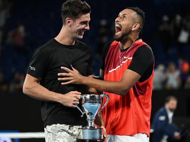 Great mates Thanasi Kokkinakis (L) and Nick Kyrgios with the championship trophy after winning their Men's Doubles Final at the 2022 Australian Open. Picture: Quinn Rooney/Getty Images