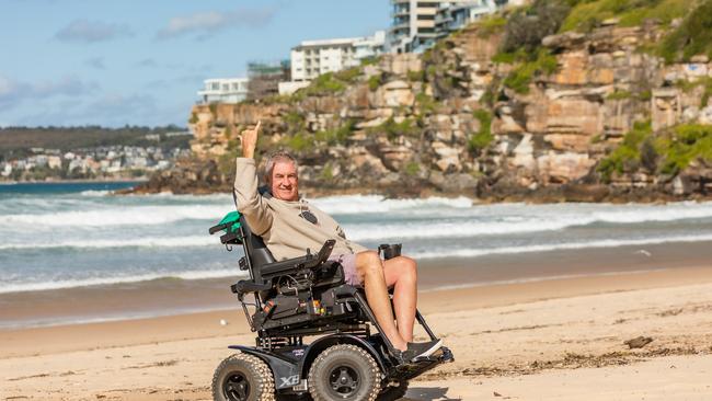 Wayne Raffo who has had MS for 16 years, has been able to return to his beloved Freshwater Beach thanks to a new all-terrain wheelchair funded by the NDIS and the support of NDIS provider MS Plus. Picture: Supplied